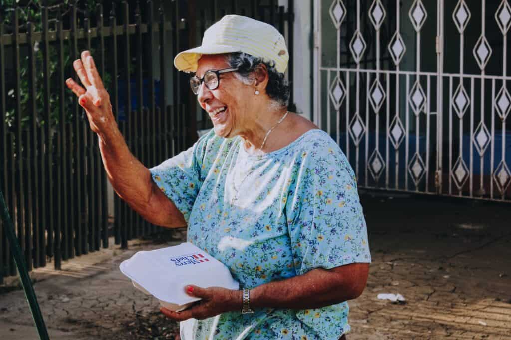 A woman thanking Mercy Chefs for a hot meal.