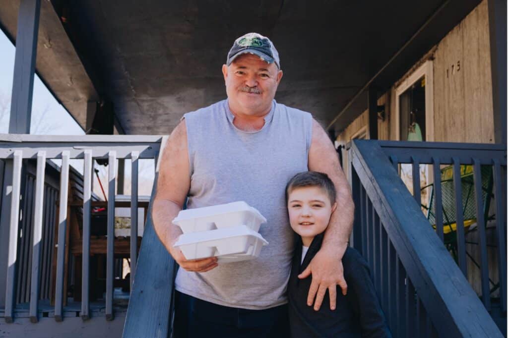 A father and son receiving a Mercy Chefs meal in the aftermath of the Kentucky floods.