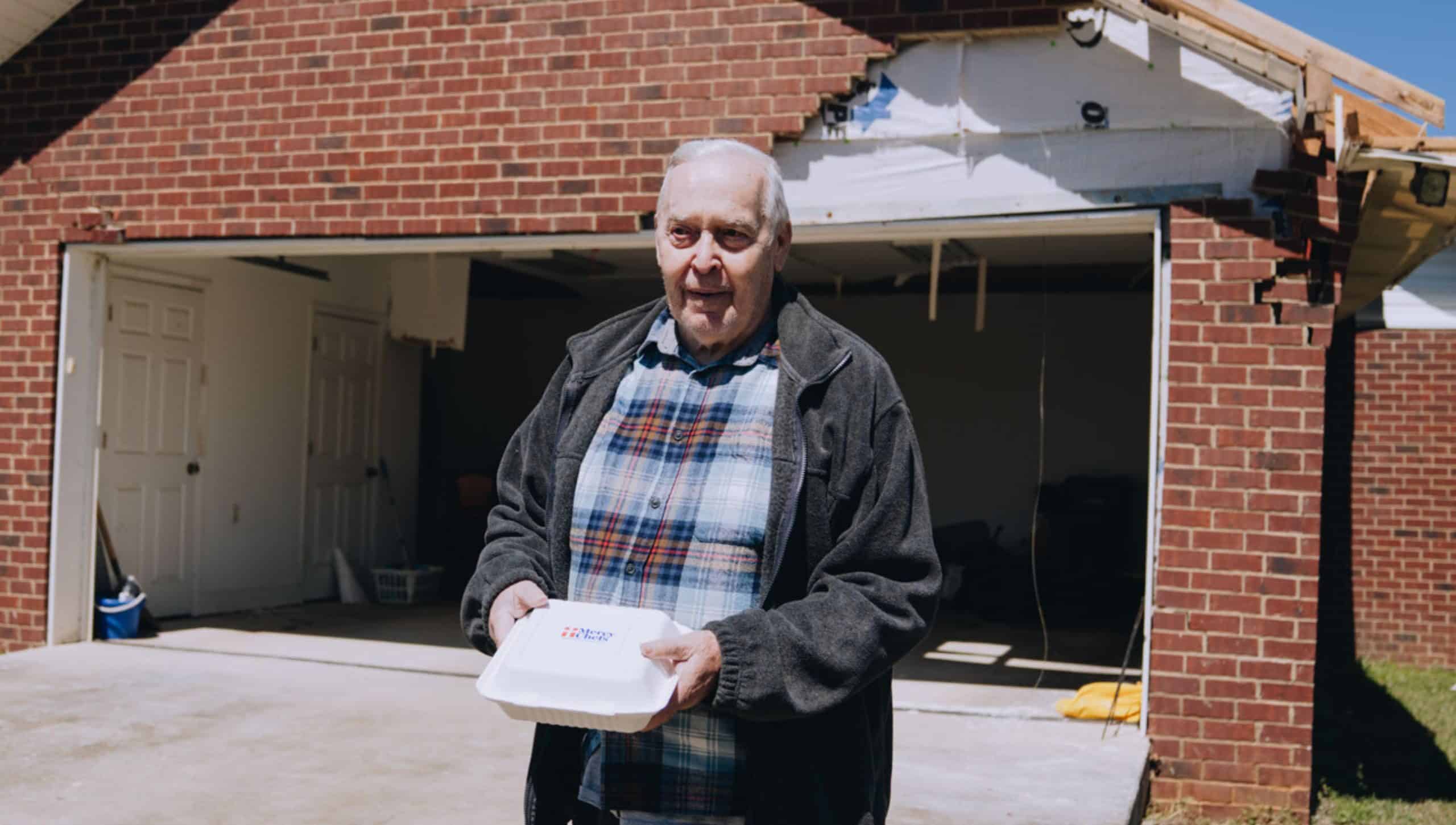 Tornado victim receiving a Mercy Chefs meal in Selmer, TN.