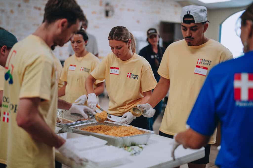 Mercy Chefs volunteers and Spur employees preparing meals for Texas flood victims