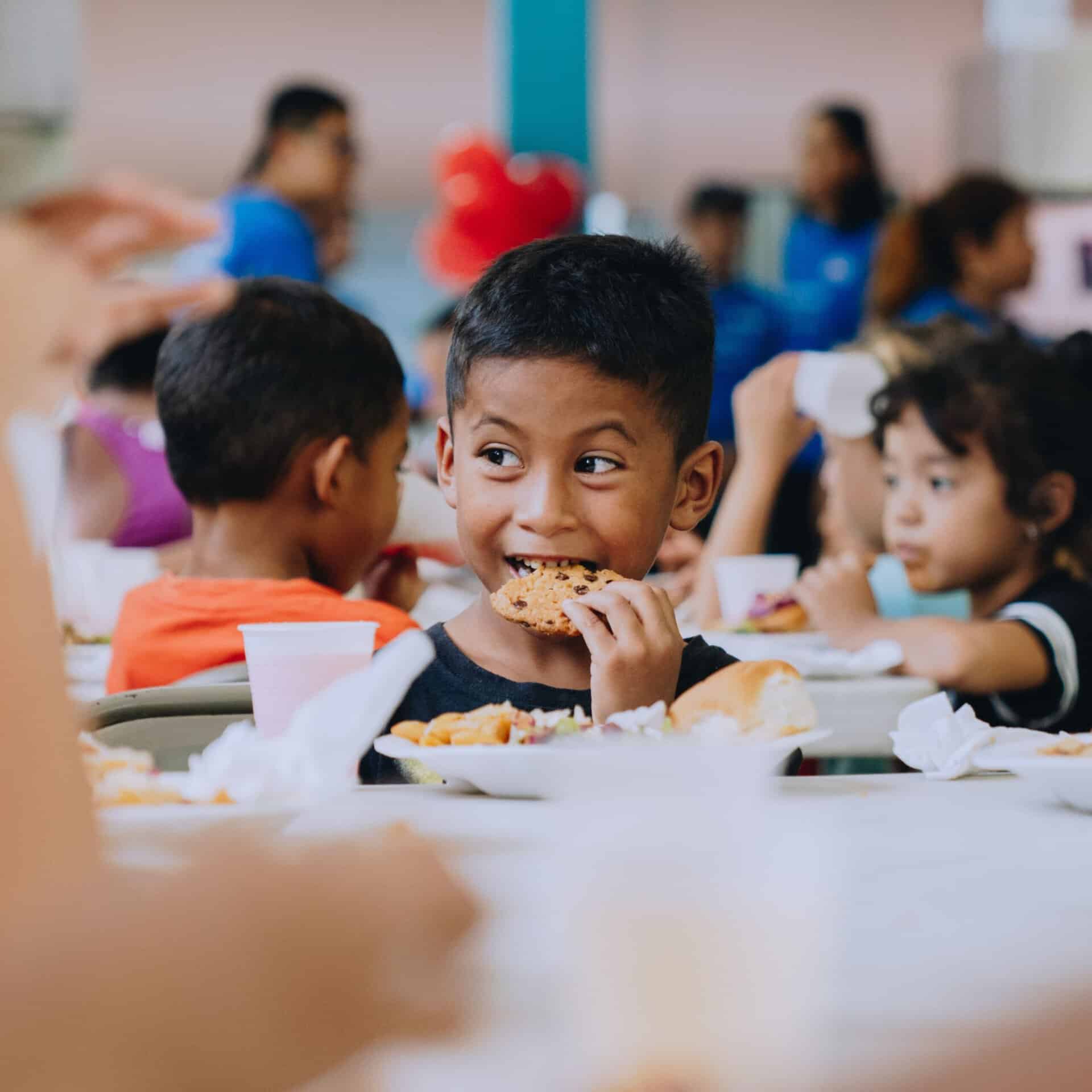 A child enjoys a Mercy Chefs' baked good in Honduras