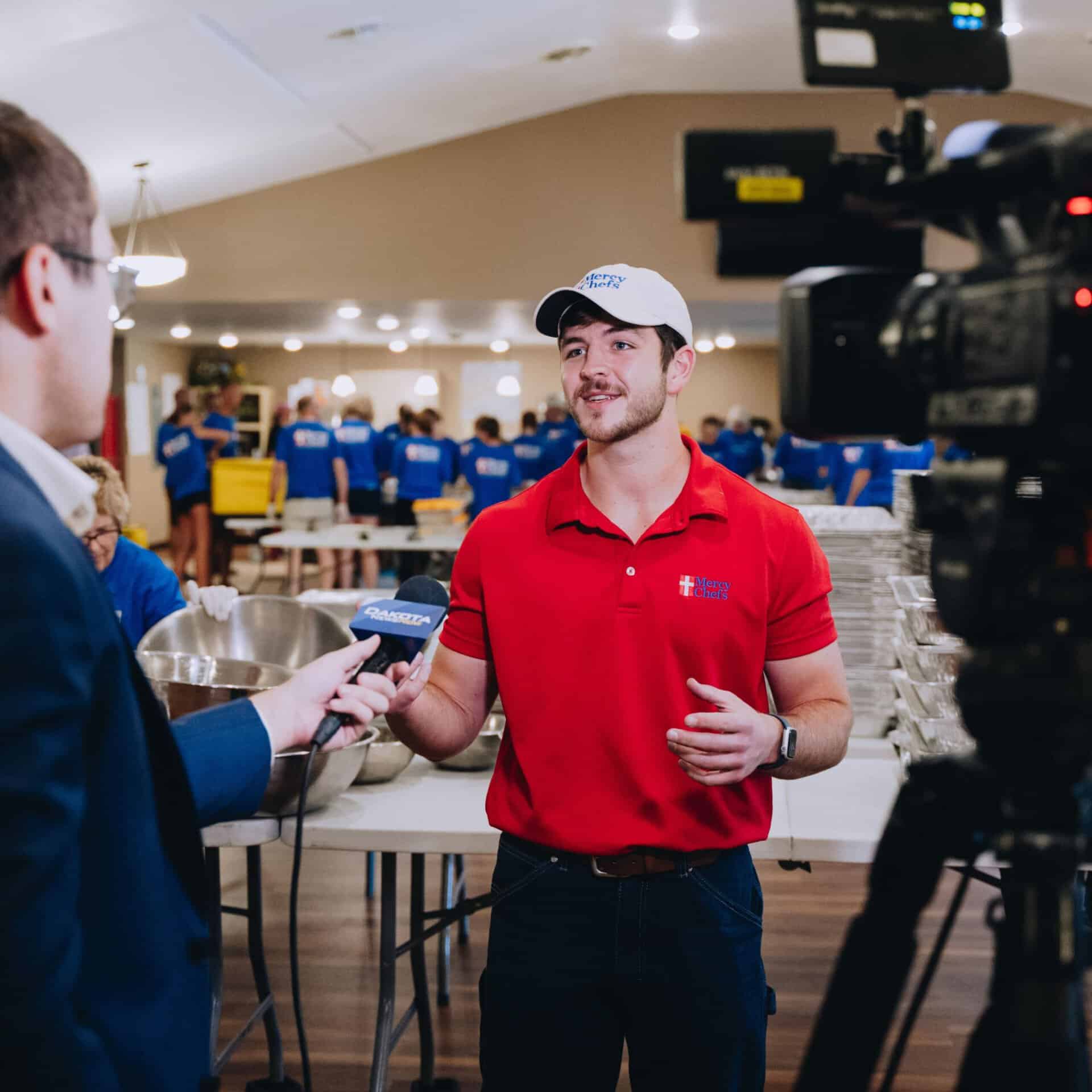 A reporter interviews Raymond LeBlanc on the ground