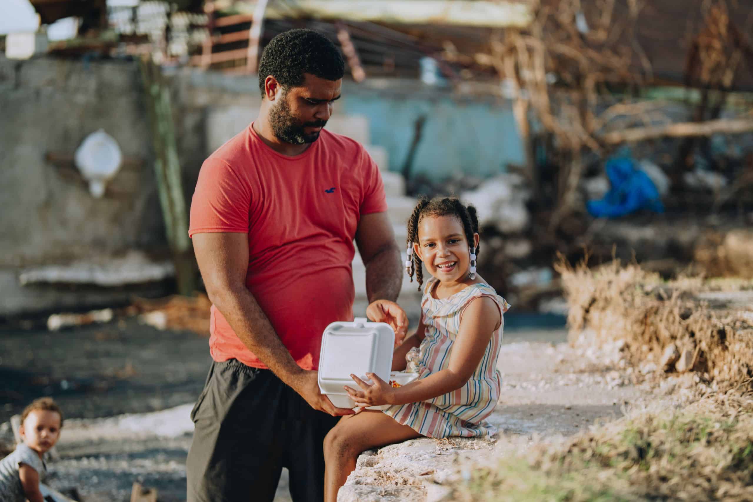 A father and daughter receive a Mercy Chefs hot meal in Jamaica