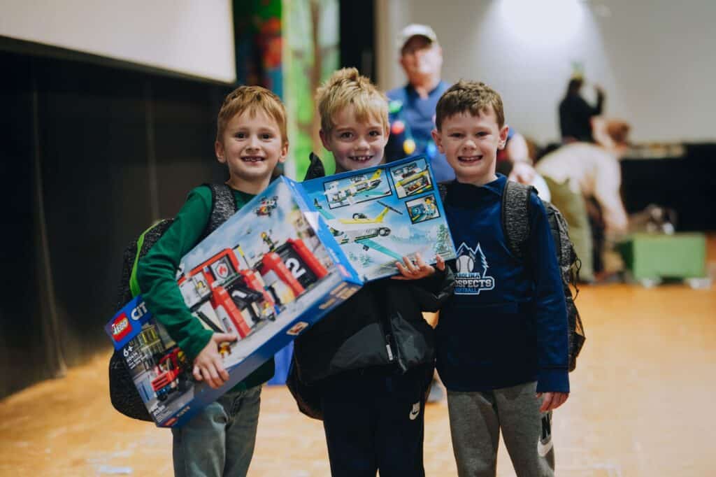 A group of boys smile as they receive Christmas gifts in North Carolina
