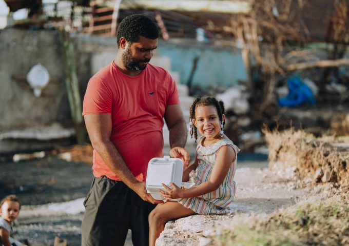 A father and daughter receive a Mercy Chefs hot meal in Jamaica