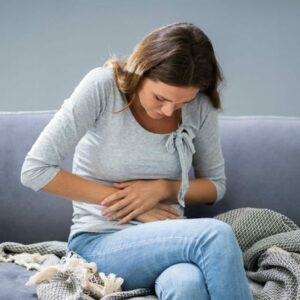woman clutching stomach