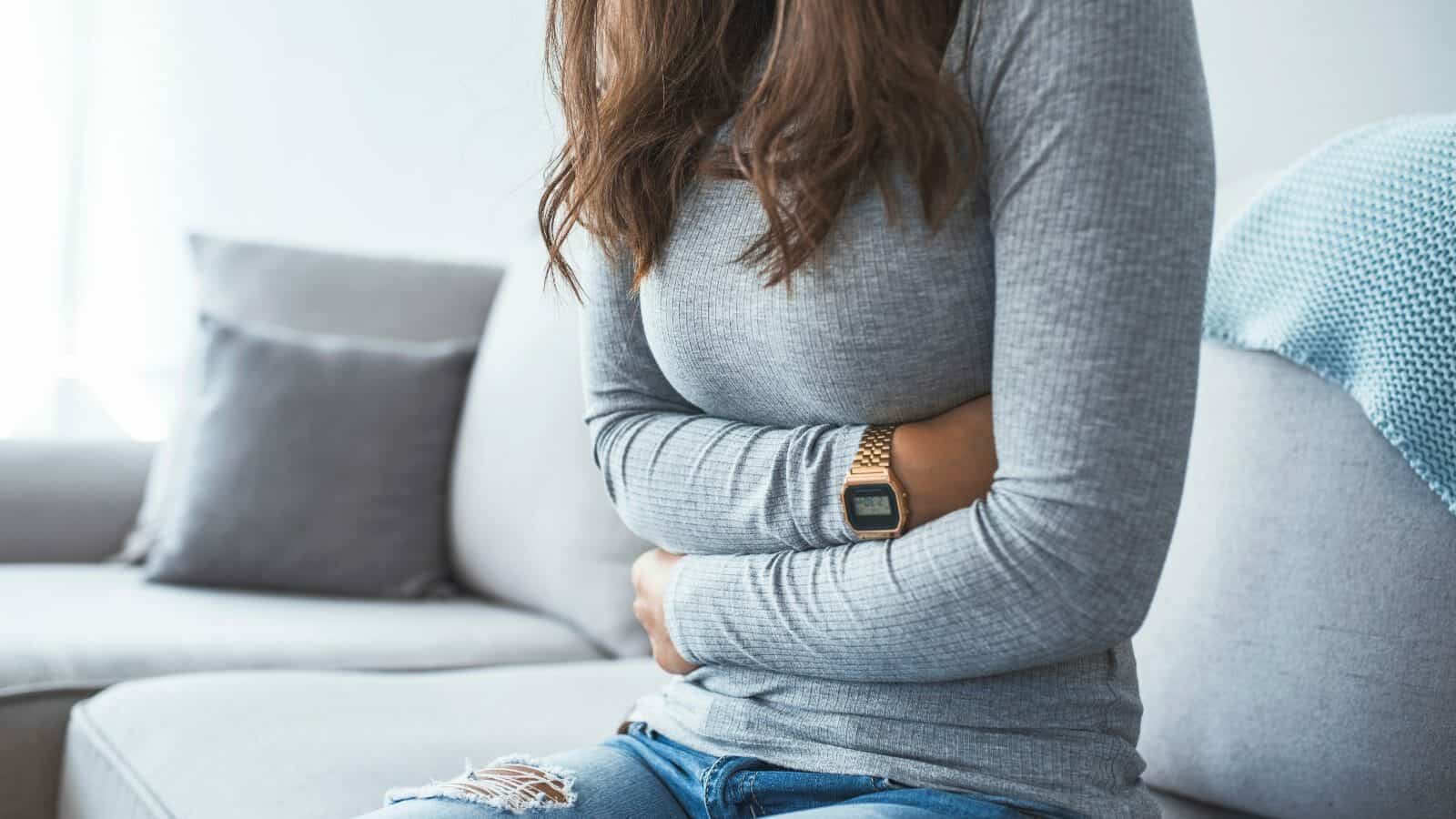 woman suffering stomach ache and pain