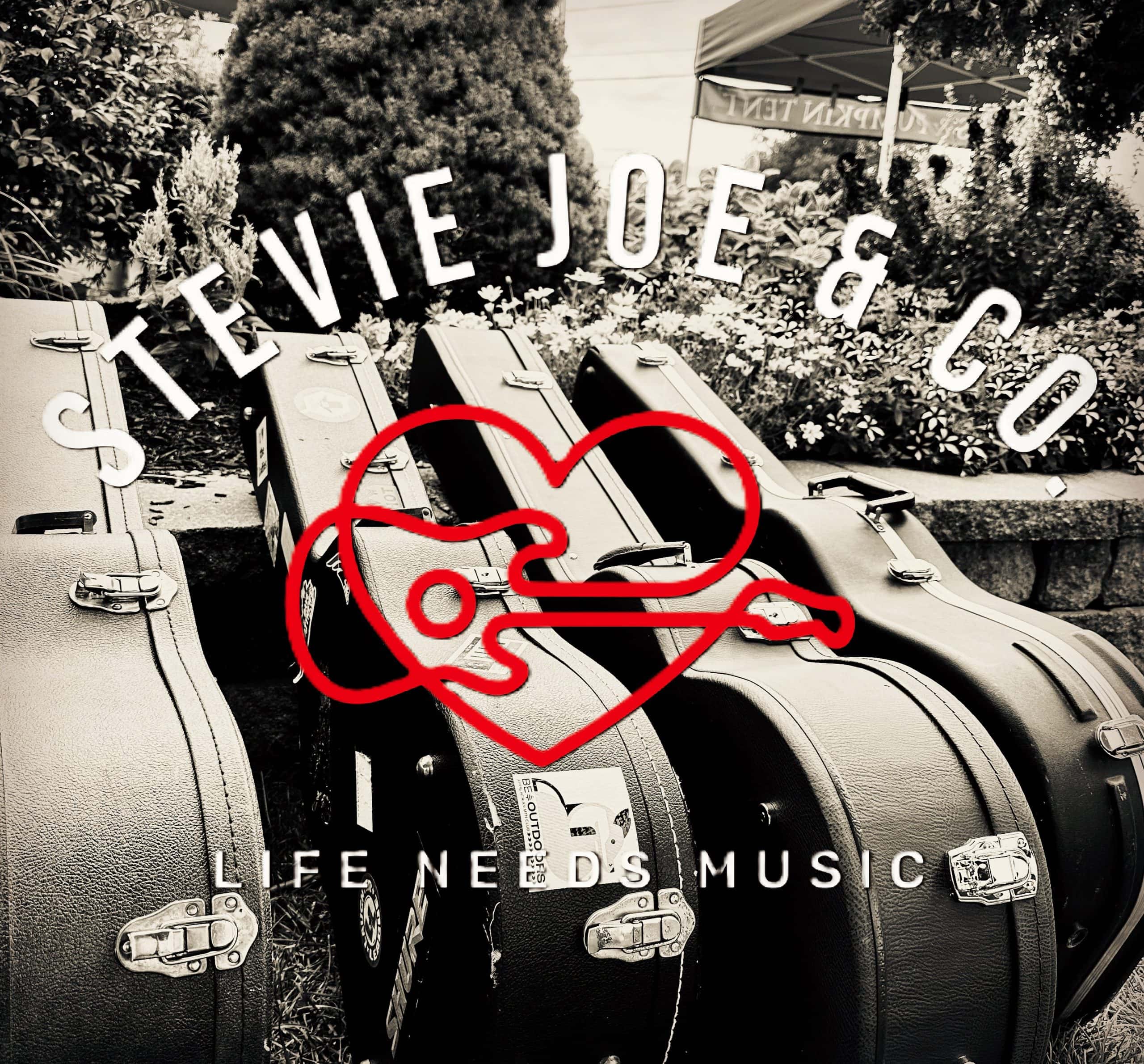 Guitar cases outside with 'Kevie Joe & Co' sign and 'Life Needs Music' text.