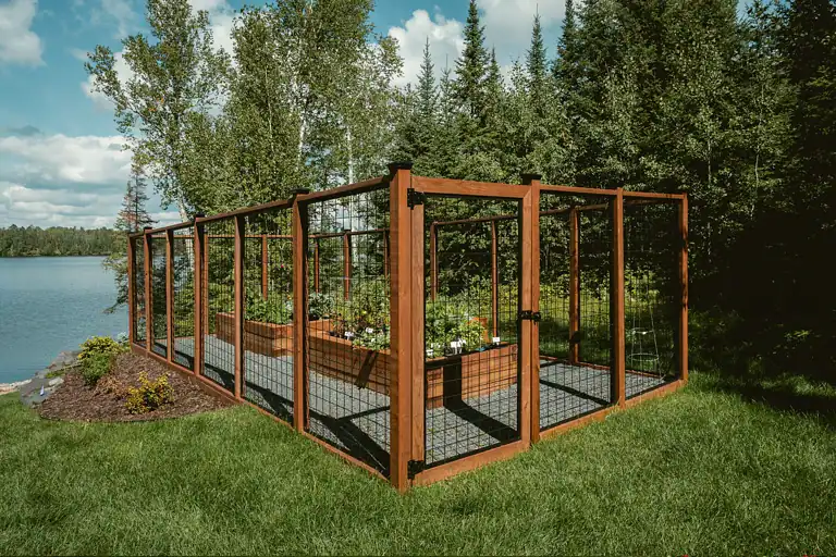 Wooden garden fencing with wire mesh panels for outdoor protection.