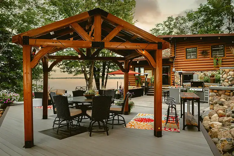 Horse arena with landscaped outdoor patio and seating area.