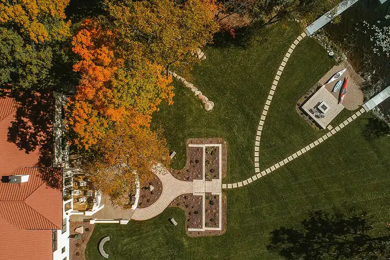 Walkways with stepping stones and garden beds in a landscaped yard.