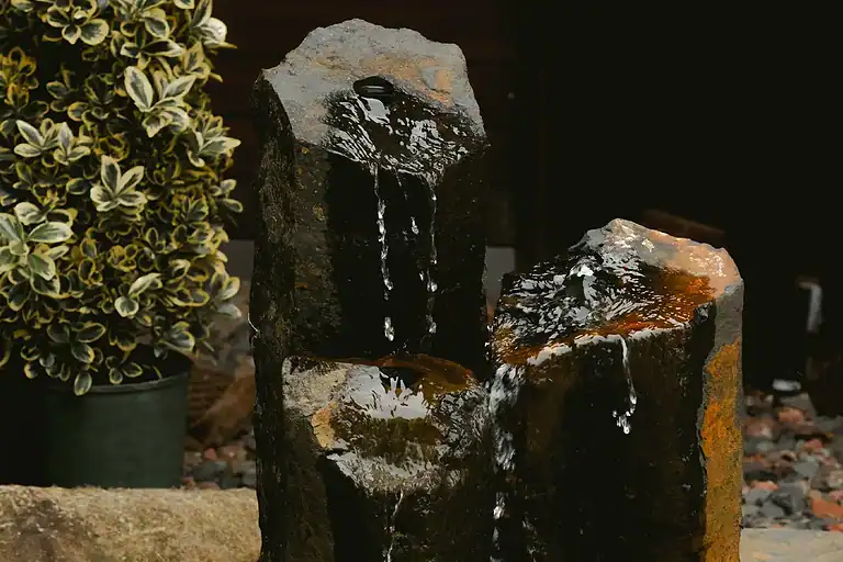 Water feature with natural rocks and flowing water.