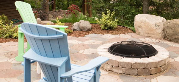 Backyard patio with fire and adirondack chairs