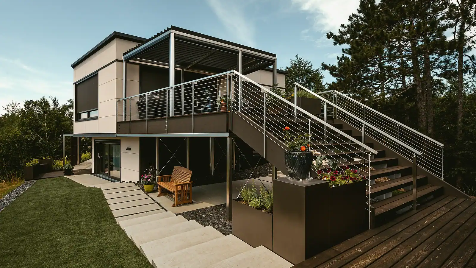 Contemporary house with landscaped yard and outdoor staircase.