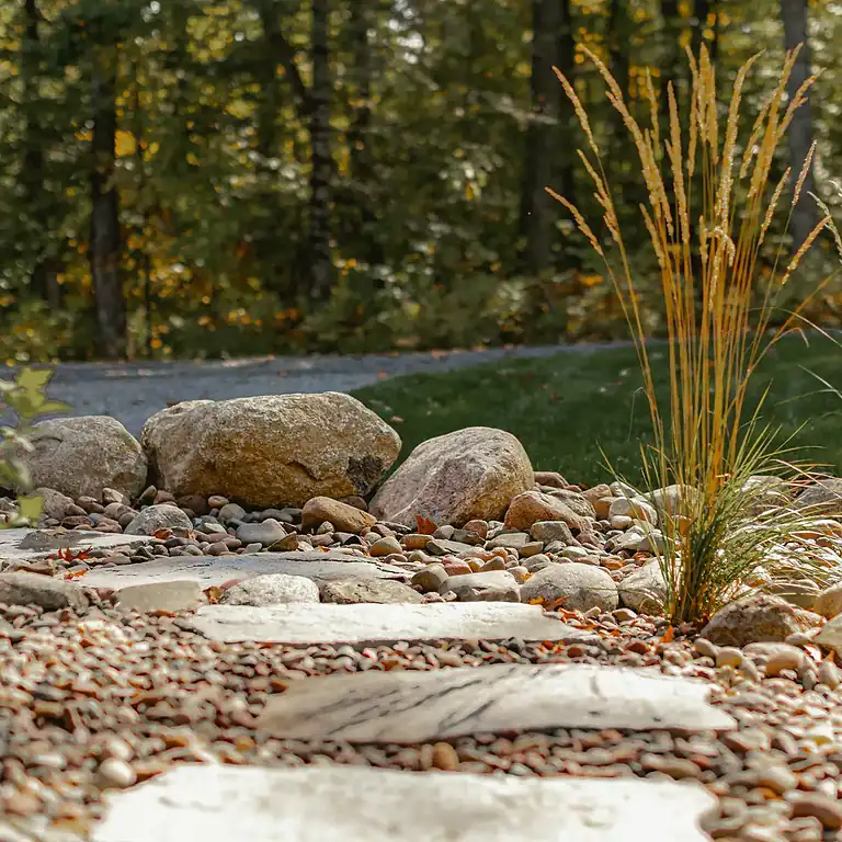 Lakeside Flow at Nebagamon with rocks and ornamental grasses by Miller Creek Lawn & Landscape.