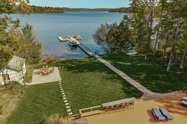 Lakeside Flow at Nebagamon with landscaped lawn and dock on the water.