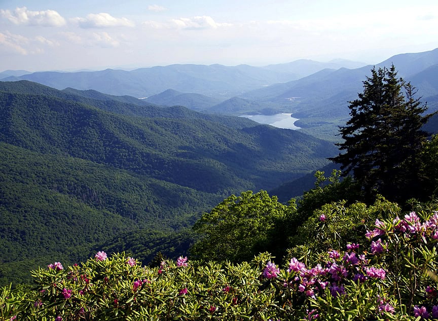 A view of a mountain range with a lake in the distance.