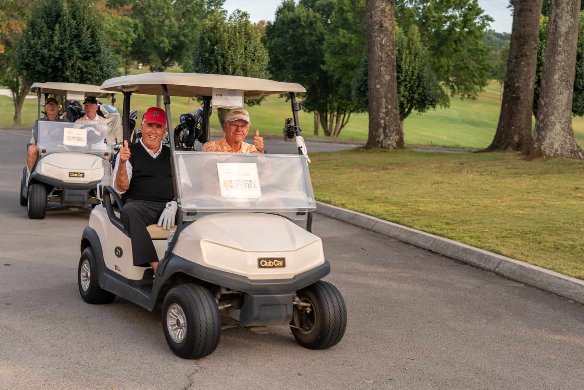 A group of people on a golf cart.