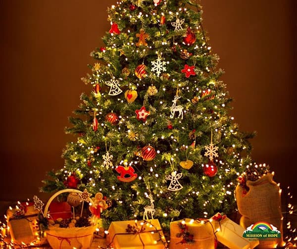 A christmas tree with gifts and decorations on a brown background.
