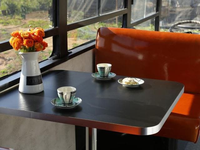 vintage buses-Abandoned Bus Remodeled into beautiful mobile home Dining Area