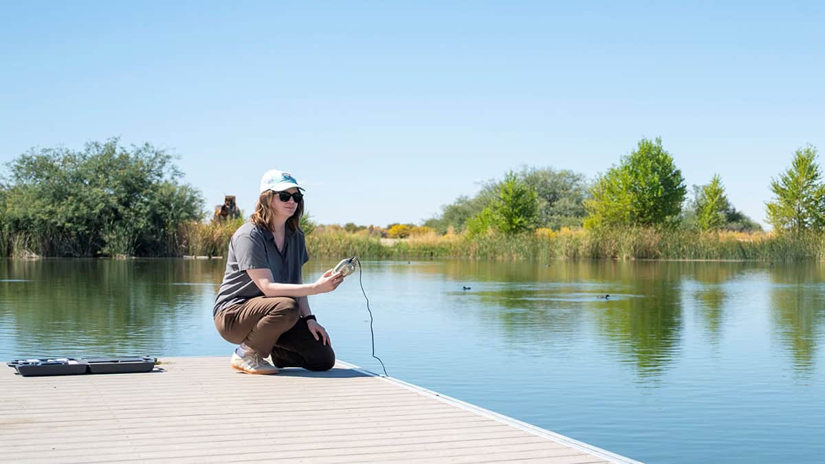 Leah Wilson, environmental planner with the 412th Civil Engineer Group, checks the pH level of the water at Branch Memorial Park Pond on Edwards Air Force Base on Oct.. 6. Wilson routinely monitors the pond's water levels, native species and vegetation to determine if environmental action is required.