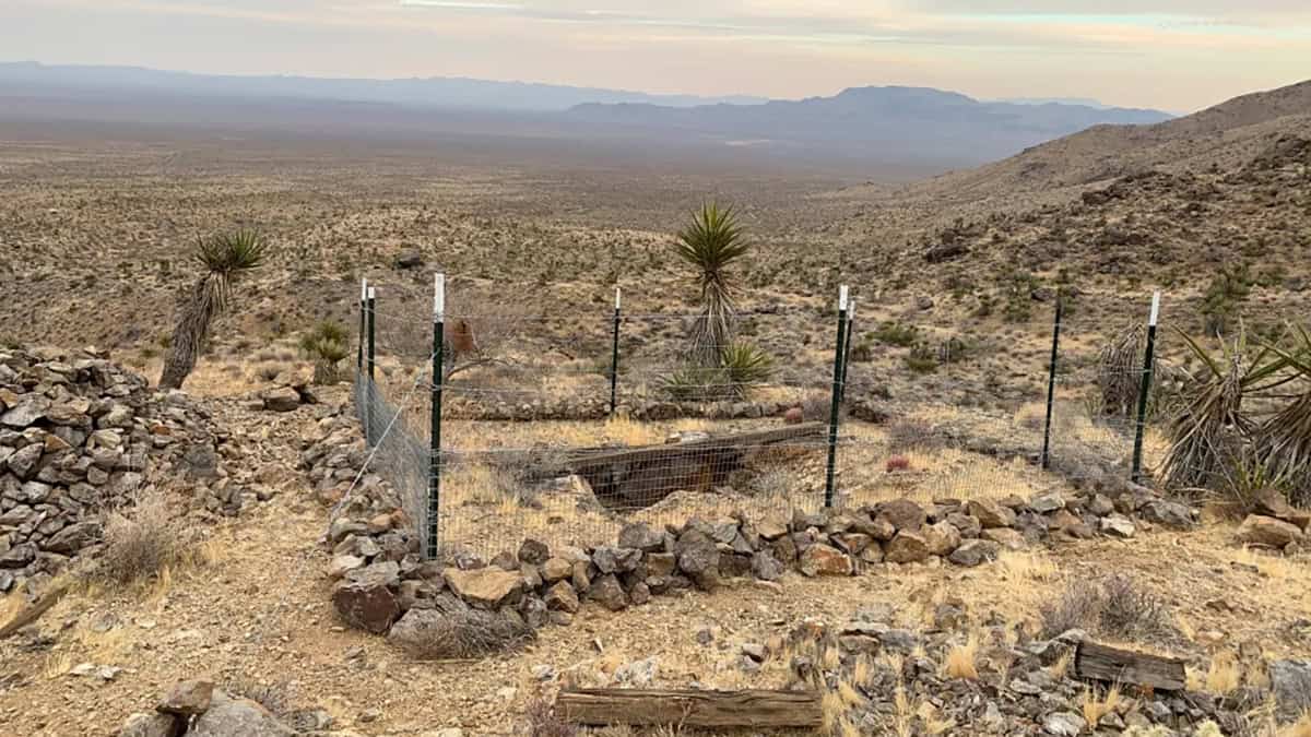 A fenced-off mine shaft in the Mojave National Preserve
