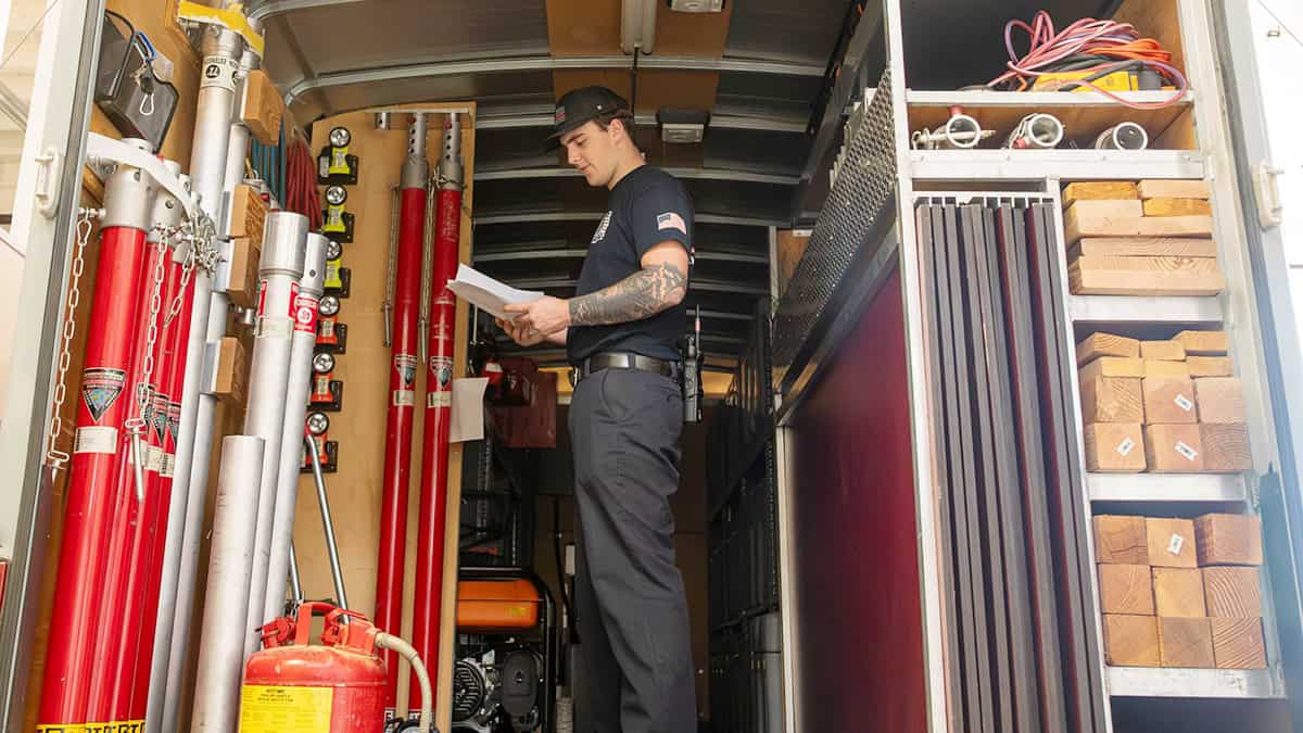 Nathaniel Fore, an 812th Civil Engineer Squadron firefighter, reviews a crash rescue vehicle checklist before responding to a simulated damaged building during an earthquake exercise at Edwards Air Force Base on Oct. 15.