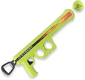 Green handheld dog ball launcher shaped like a cannon with tennis ball loaded and ready to fire.