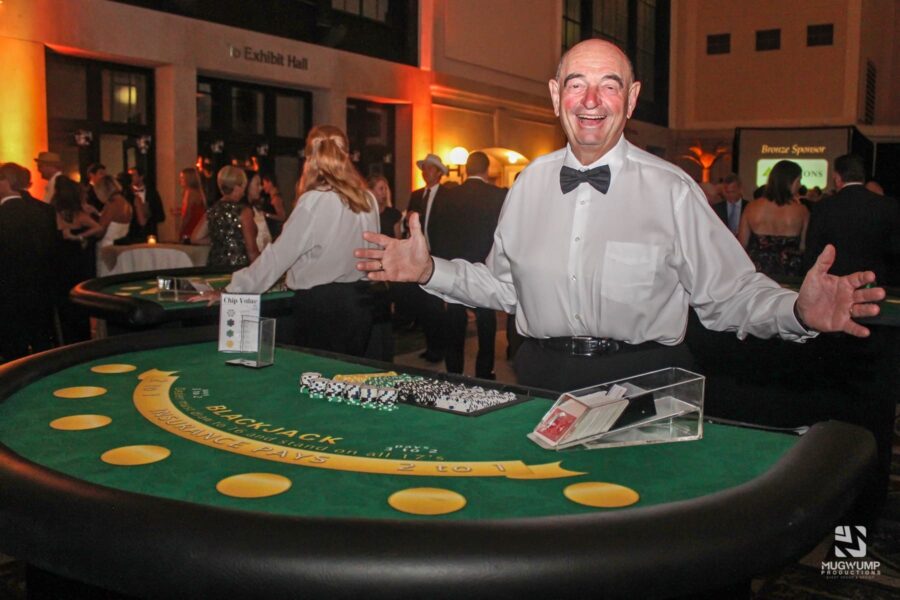 Man working a blackjack station for a casino themed party