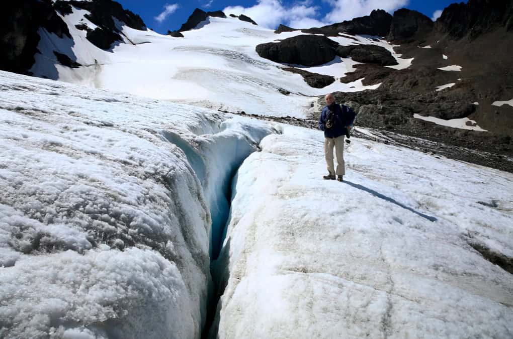 Hiker on the Vinciguerra Glacier next to a blue-ice crevasse, Ushuaia
