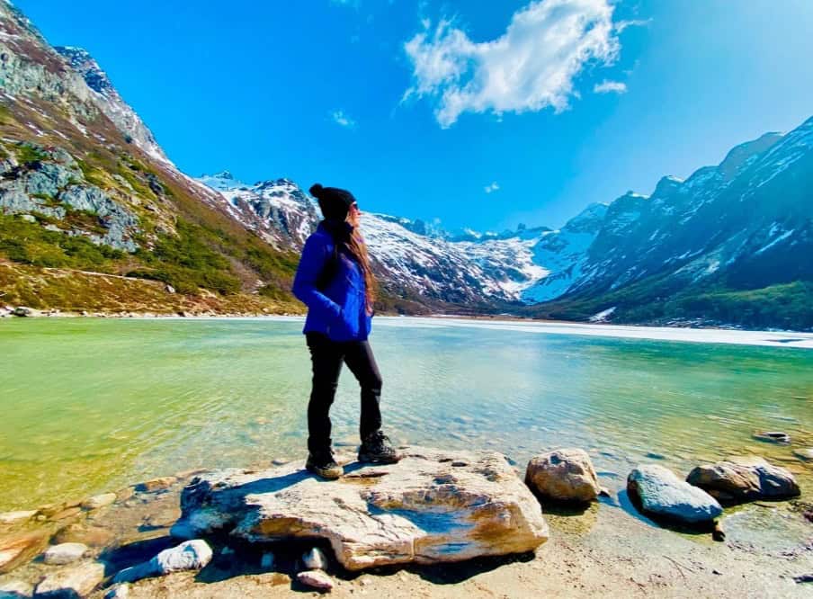 Hiker at a viewpoint over the turquoise lagoon, trekking to the Ojo del Albino Glacier, Ushuaia