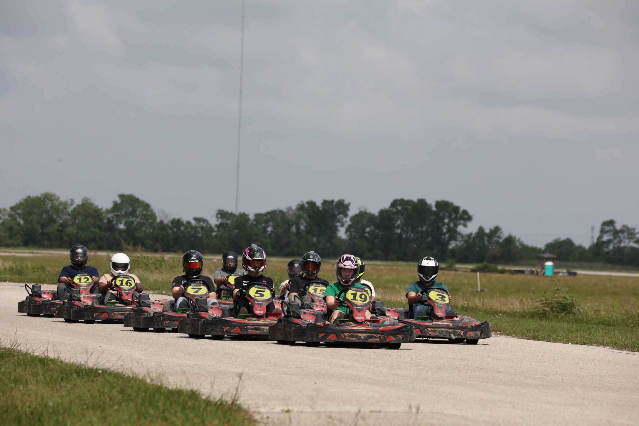 Group of racers in go-karts on track during Mustang Week event.