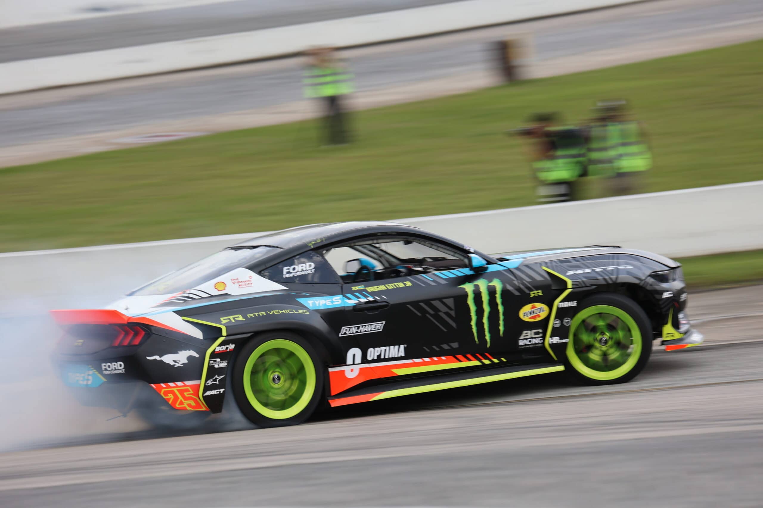 High-speed race car with Monster Energy branding on a race track.
