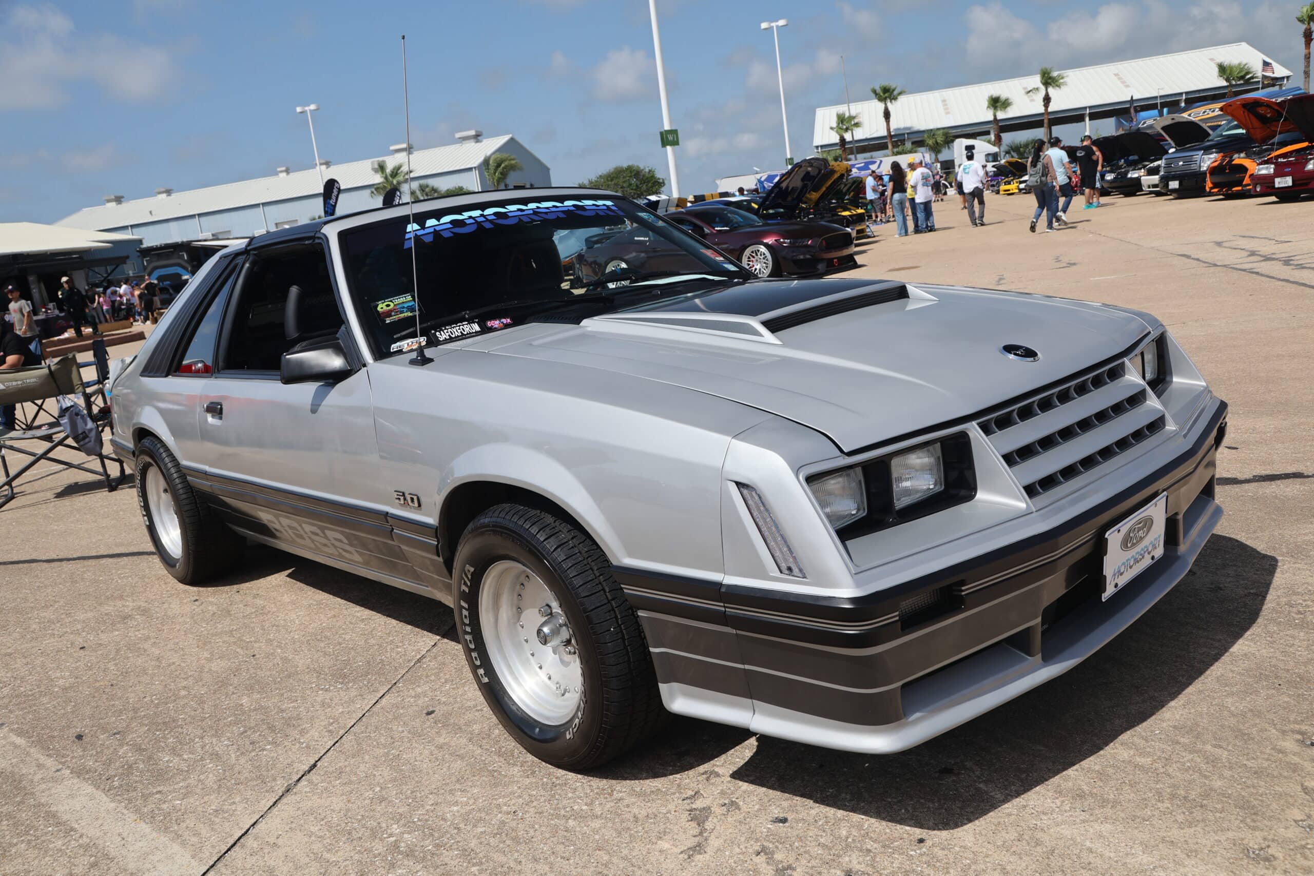 Silver vintage Ford Mustang with custom modifications at Mustang Week event.