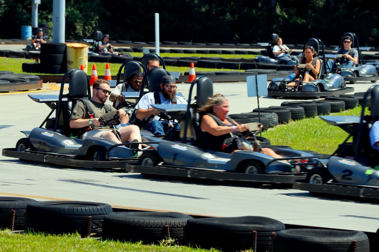 Group of people racing go-karts at Mustang Week event in Myrtle Beach.