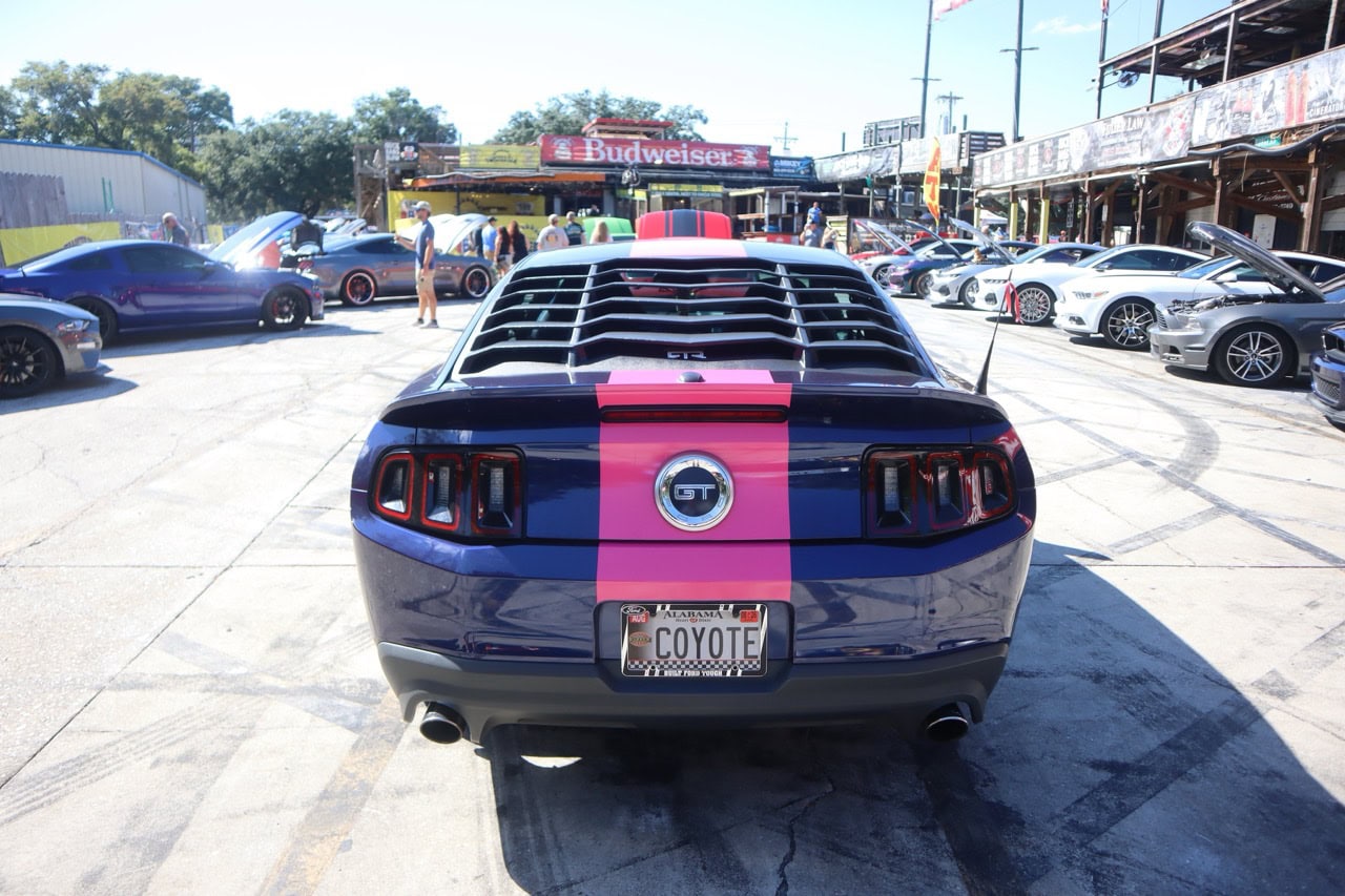 Blue Ford Mustang GT with pink racing stripe at Myrtle Beach 2025 event.