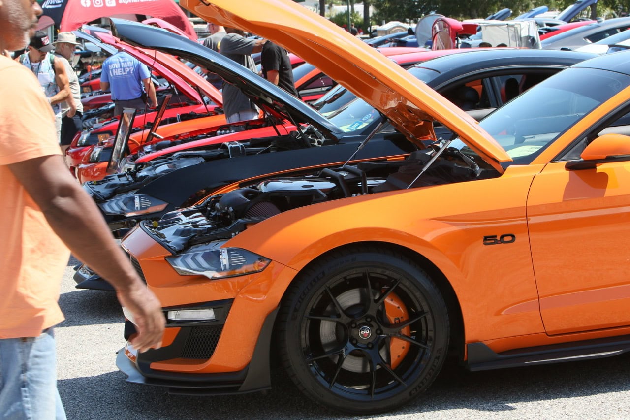 Mustang Week car show at Myrtle Beach 2025 featuring vibrant orange Ford Mustang on display.