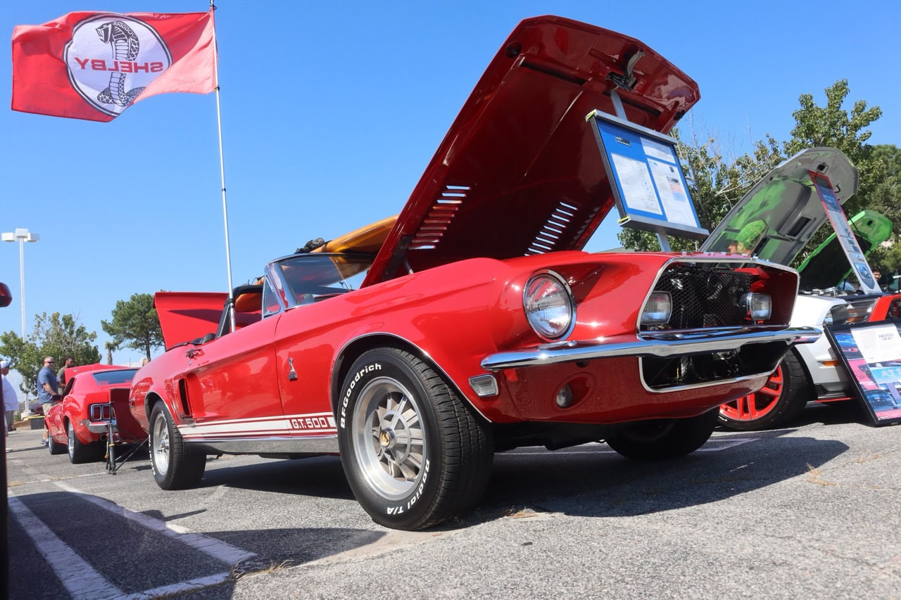 Mustang Week vintage car with open hood showcasing engine.