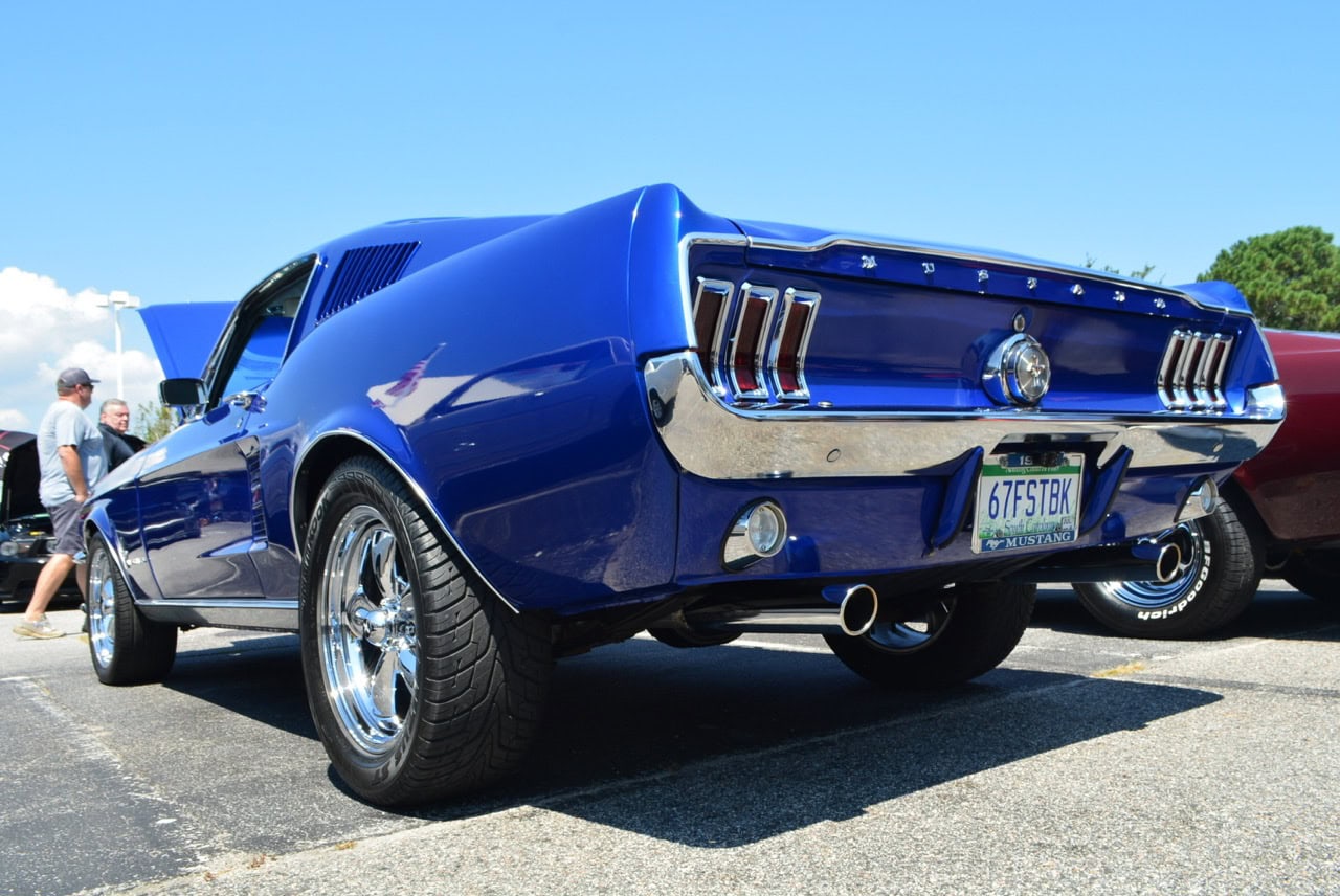 Mustang Week car show featuring a blue vintage muscle car.