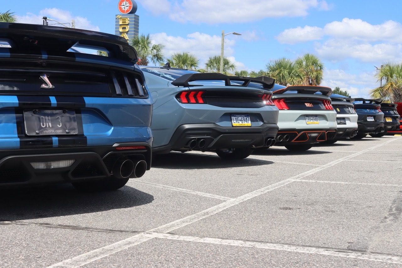 Row of sleek Ford Mustangs parked at Myrtle Beach during Mustang Week 2025.