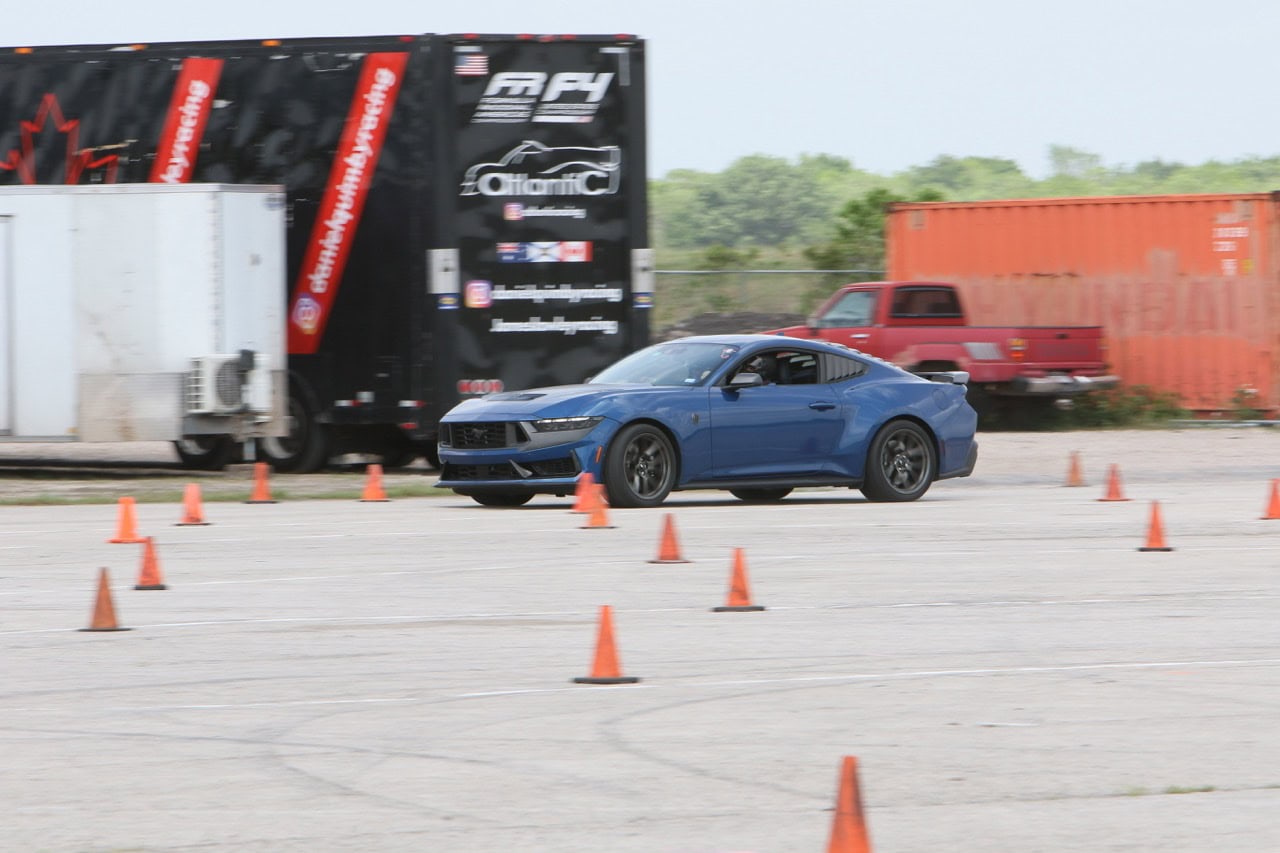 Blue Mustang navigating cones at Mustang Week event.