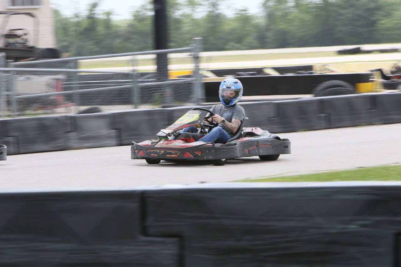 Go-kart racing on a track during Mustang Week event.