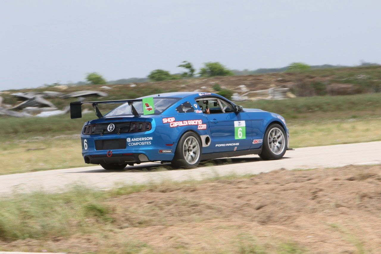 Mustang Week race car on dirt track in Texas 2026 event.