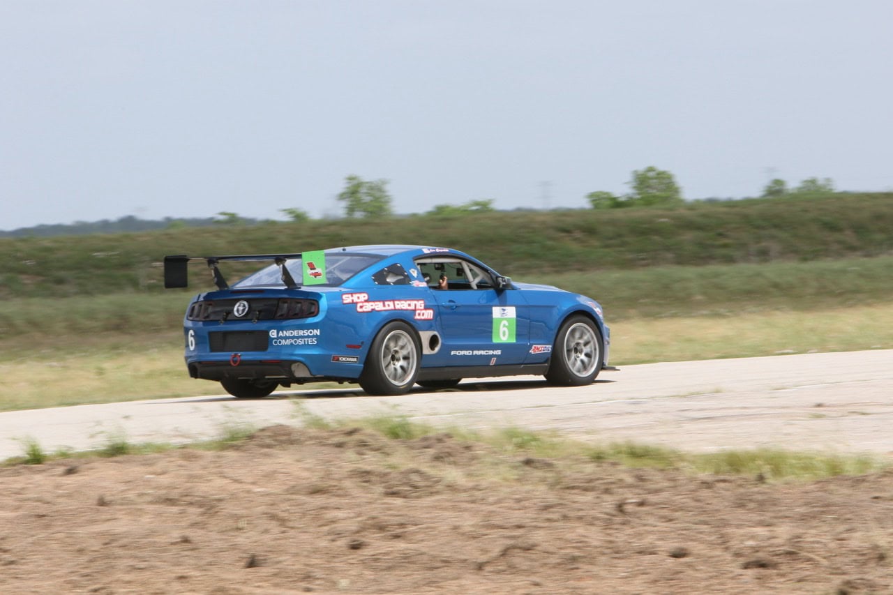Race car on track at Mustang Week event.