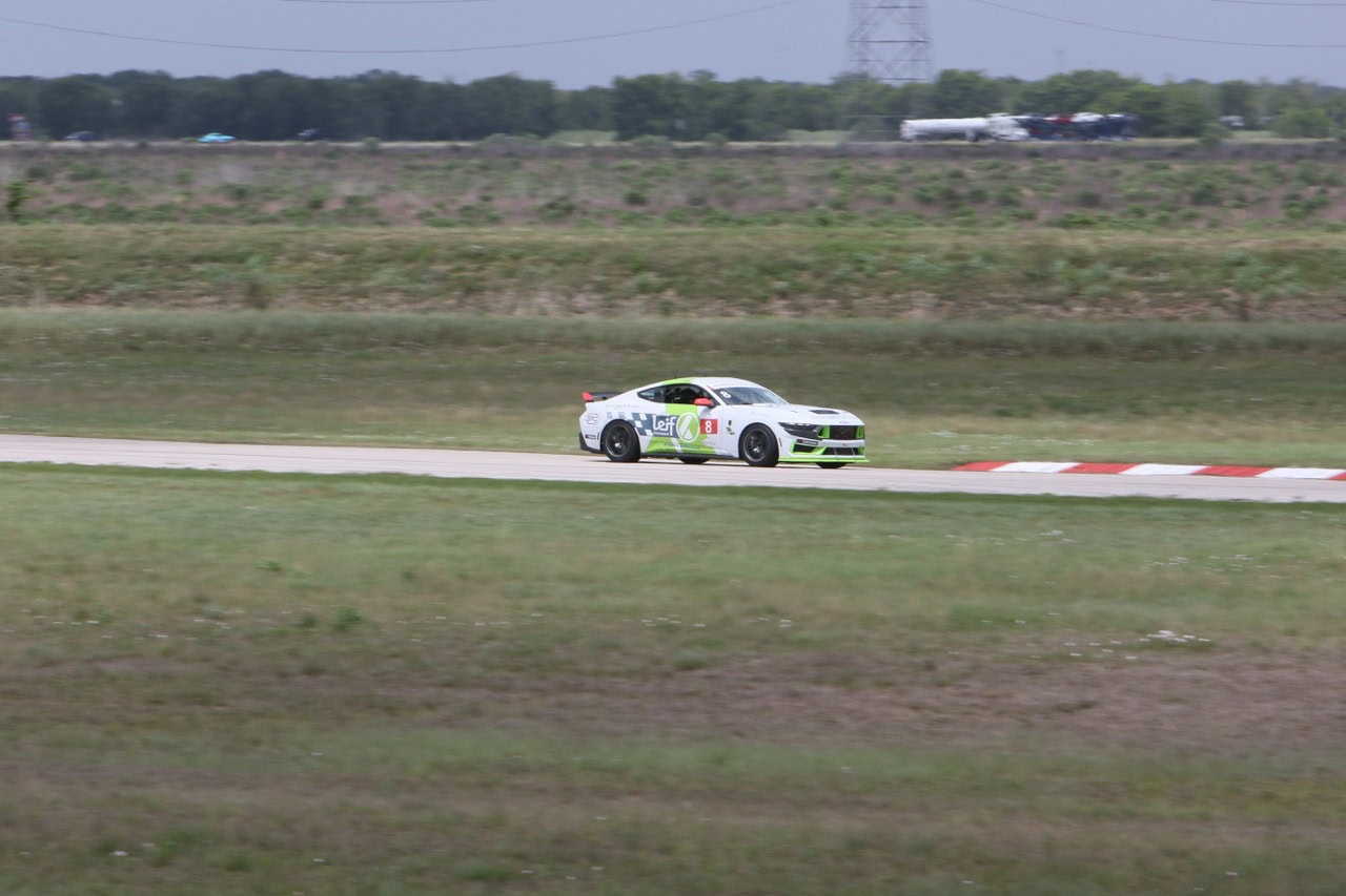 Mustang Week race car driving on the track during event.