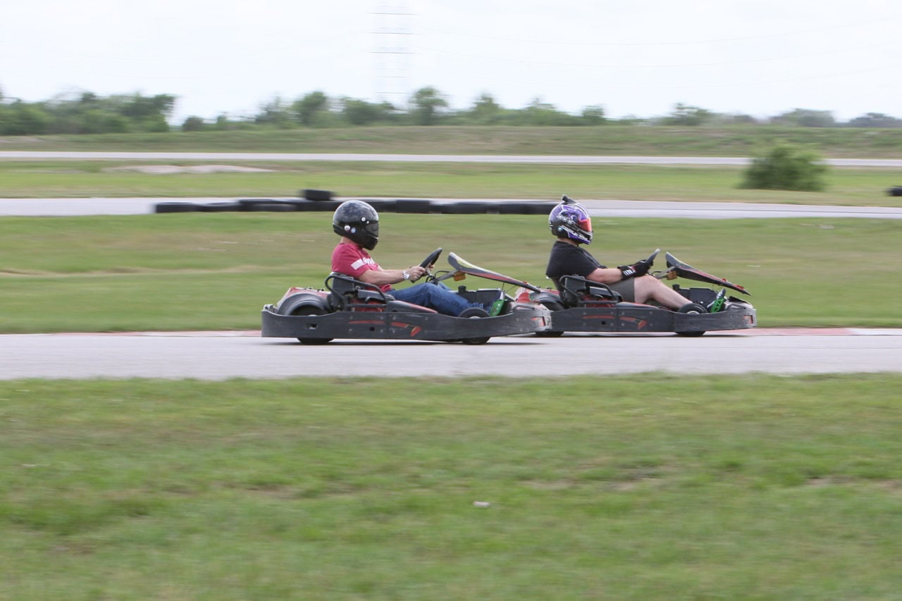 Two people racing go-karts at Mustang Week event in Texas 2026.