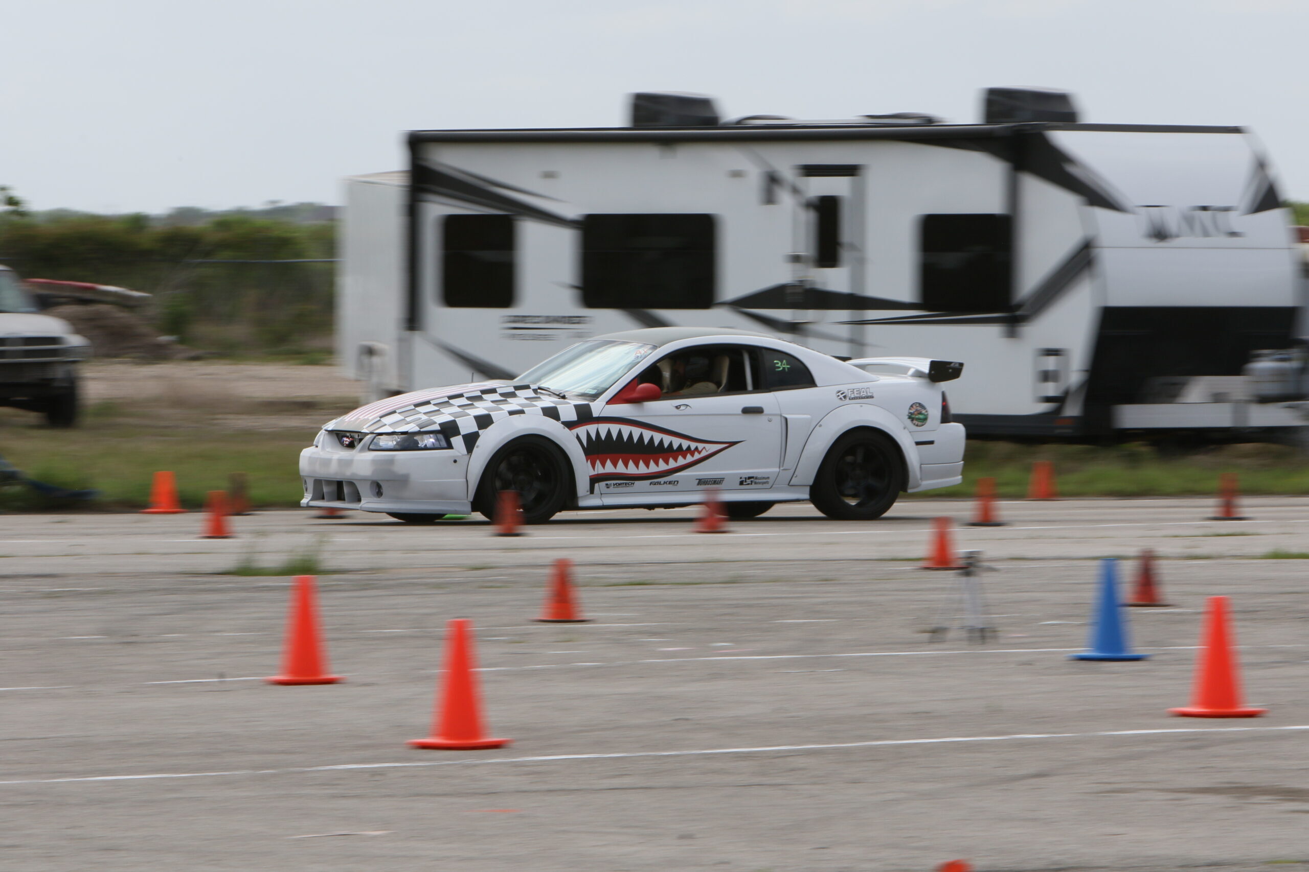 Mustang racing car navigating cones at Mustang Week event.