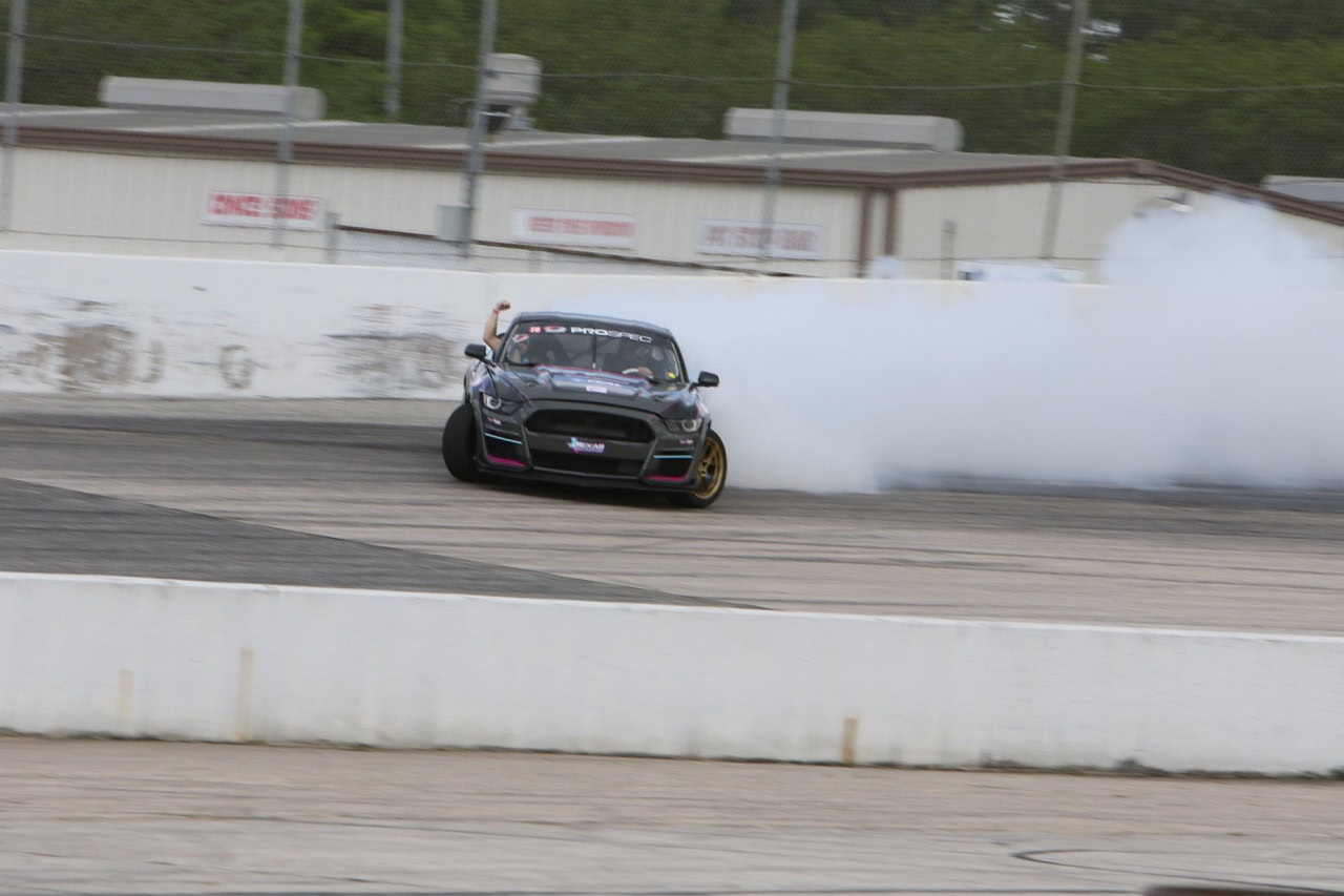 Mustang Week drifting on the track with tire smoke.