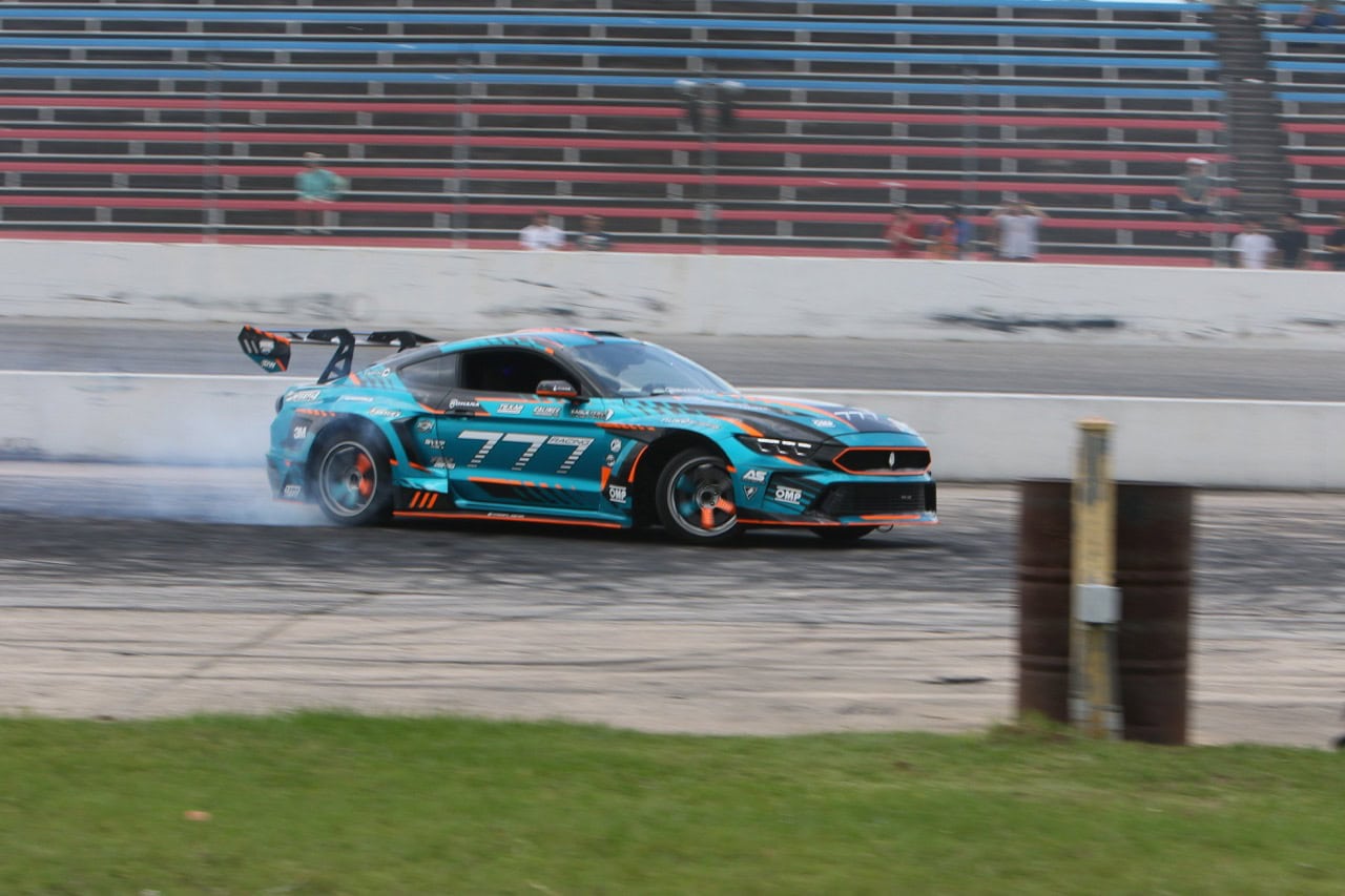 Blue Ford Mustang racing at Mustang Week event in Texas 2026.