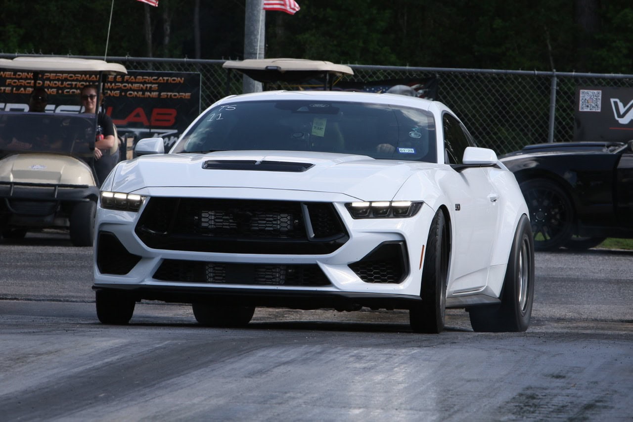 High-performance white Ford Mustang at Mustang Week event.